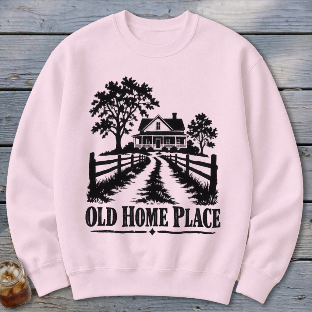 Pink sweatshirt with black silhouette of a house, trees, fence, and text "OLD HOME PLACE".