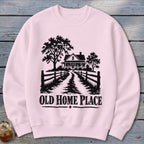 Pink sweatshirt with black silhouette of a house, trees, fence, and text "OLD HOME PLACE".
