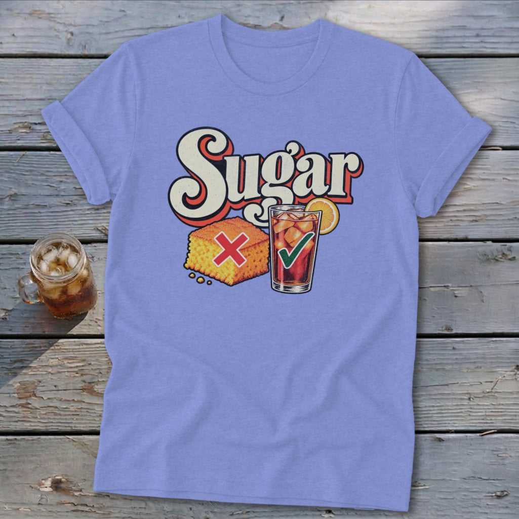 Periwinkle t-shirt with a graphic of cornbread marked with a red X and iced tea with a green checkmark below the text Sugar.