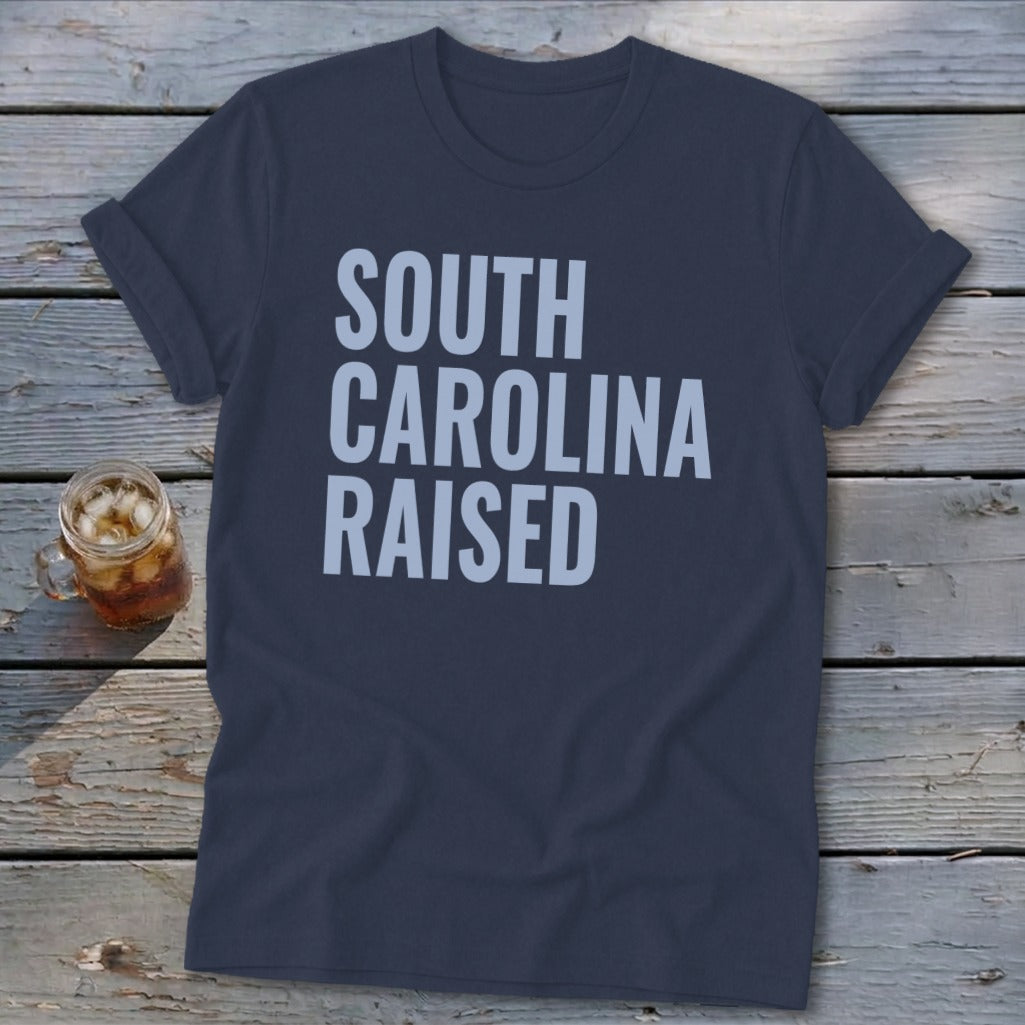 Navy t-shirt with light blue text reading "SOUTH CAROLINA RAISED".