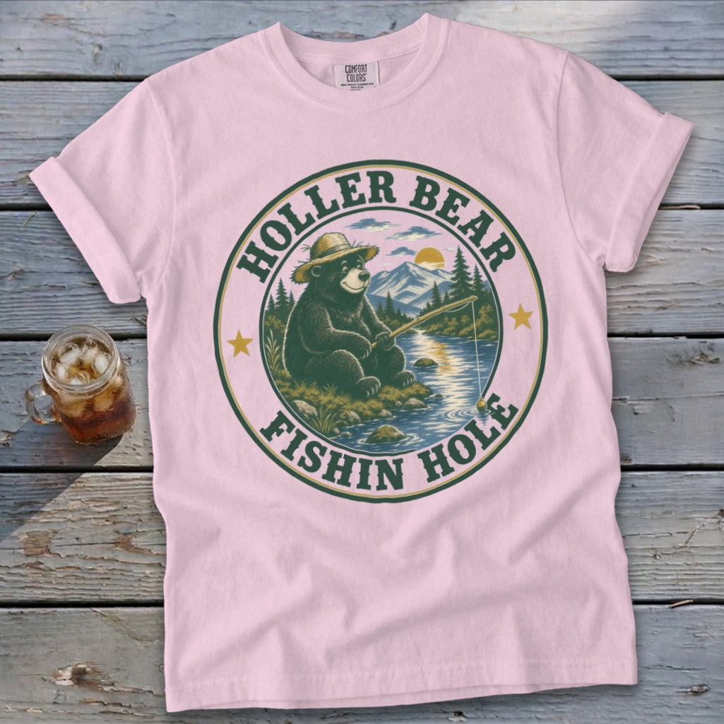 Pink t-shirt with a circular graphic featuring a bear fishing. Text reads "HOLIER BEAR FISHIN HOLE".
