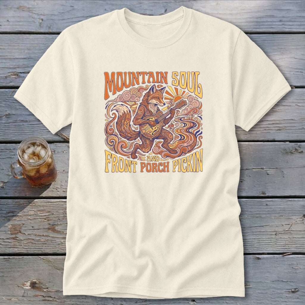 Cream t-shirt with a stylized fox playing a guitar and "Mountain Soul and Front Porch Pickin" text.