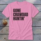 Pink t-shirt with black text reading "GONE CRAWDAD HUNTIN'".