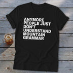 Black t-shirt with white text reading "ANYMORE PEOPLE JUST DON'T UNDERSTAND MOUNTAIN GRAMMAR".