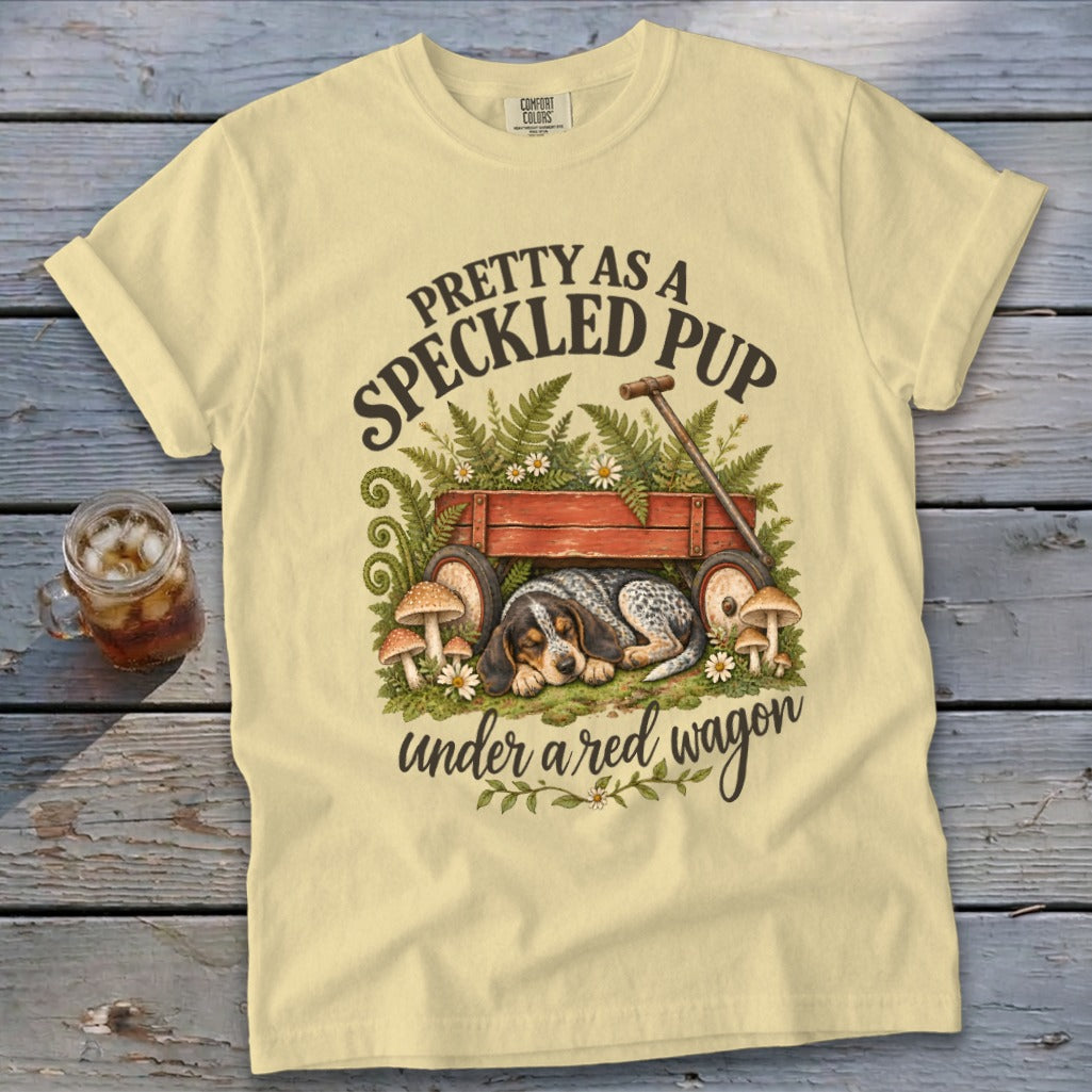 Yellow t-shirt with "Pretty as a Speckled Pup" and a sleeping dog under a red wagon.