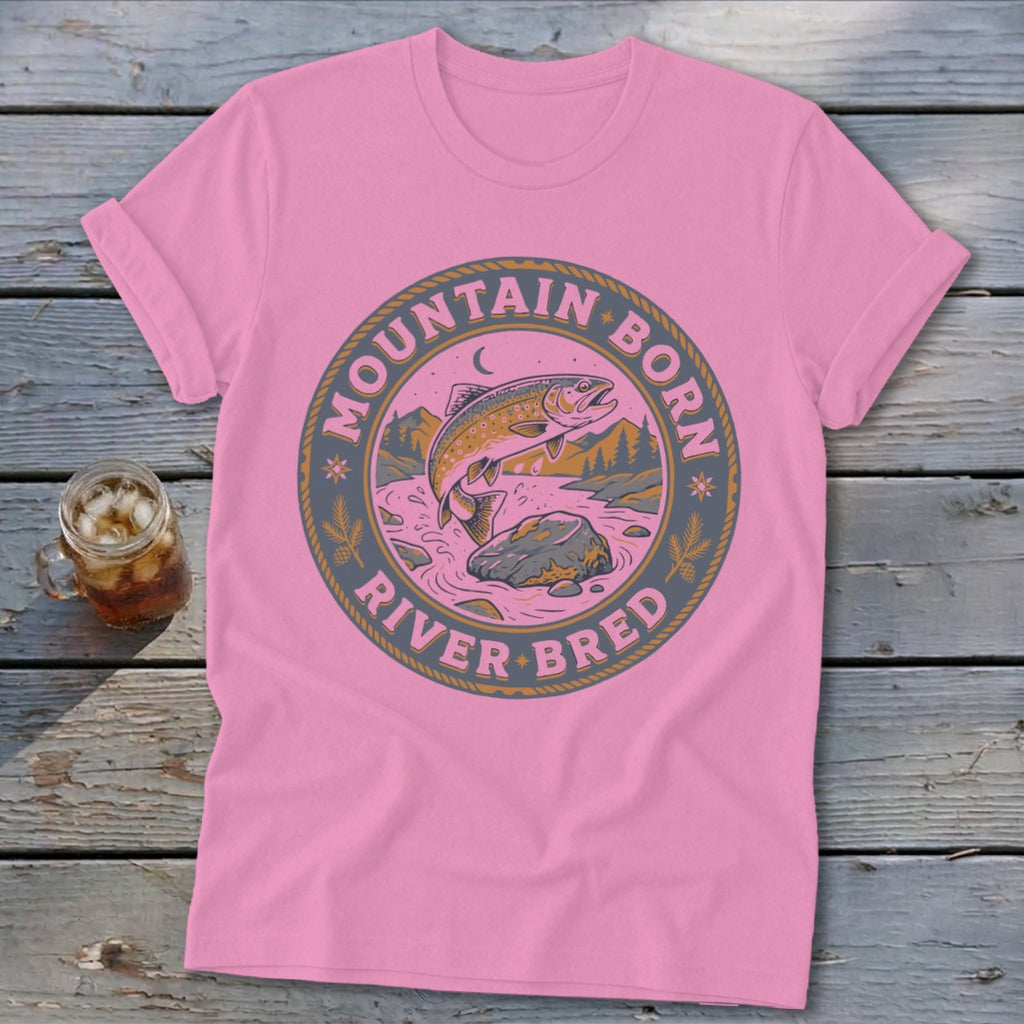 Pink t-shirt with "Mountain Born River Bred" text and leaping trout graphic.