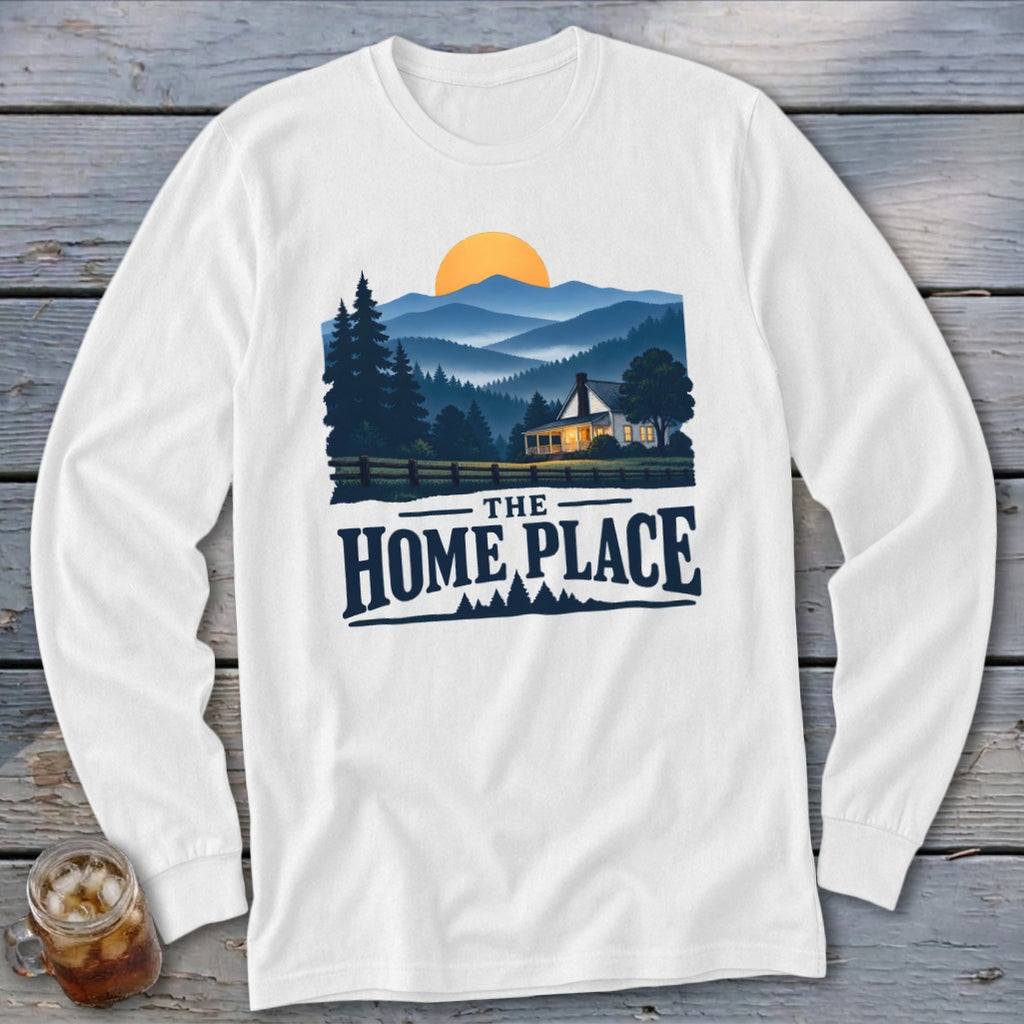 White long-sleeve shirt with a graphic of a house in mountains and text "The Home Place."