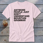 Pink t-shirt with black text reading "anymore people just don't understand mountain grammar".