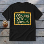 A black t-shirt features a vintage marquee sign graphic that reads Dinner on the Grounds.