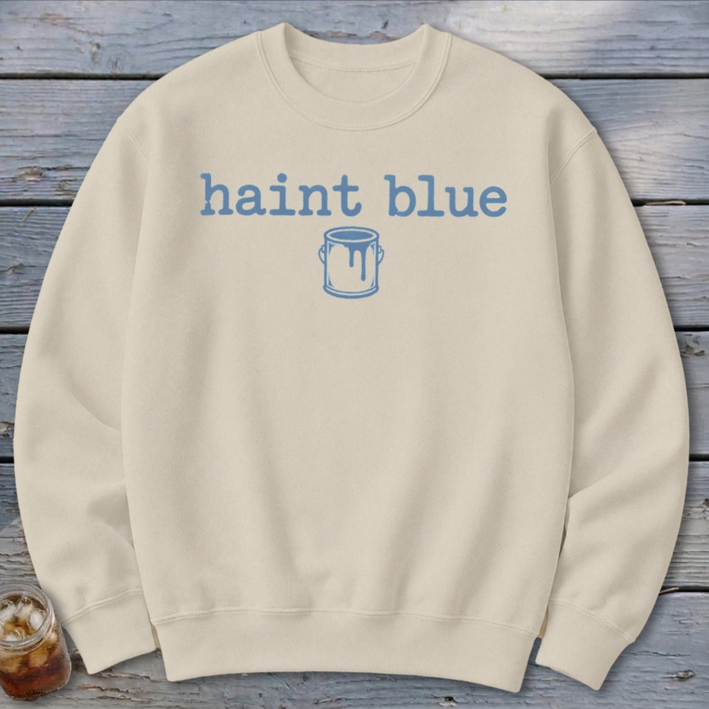 Cream sweatshirt with blue "haint blue" text and paint can graphic.