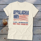 A cream-colored t-shirt printed with a distressed American flag and text that reads Appalachia, 13 states, one mountain range, one free country.