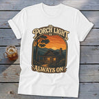 White t-shirt with "The Porch Light is Always On" graphic featuring a cabin at sunset.