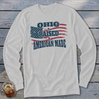Light gray long-sleeve t-shirt with a distressed American flag graphic and the text Ohio Raised American Made.