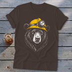 Brown t-shirt with a drawing of a bear wearing a yellow hard hat with a headlamp.
