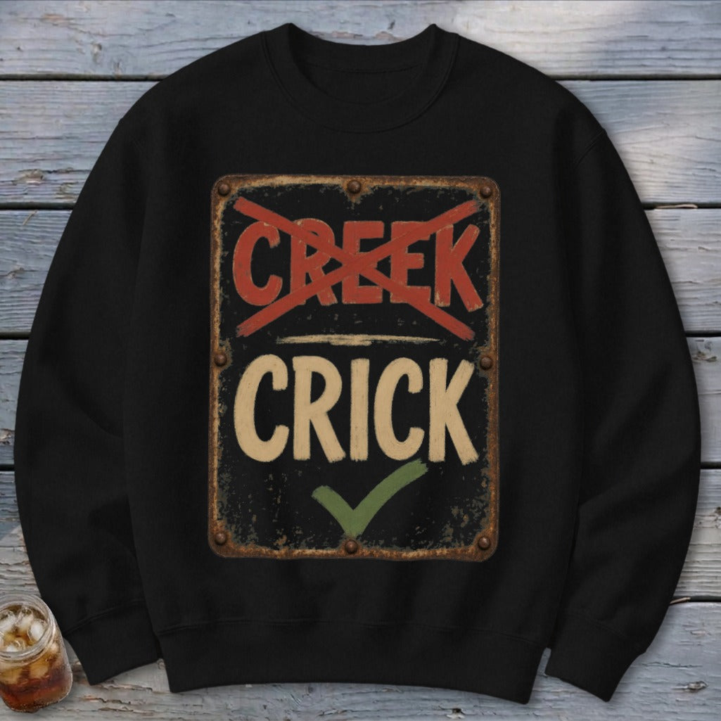 Black sweatshirt with a distressed sign reading "CRICK" with "CREEK" crossed out.