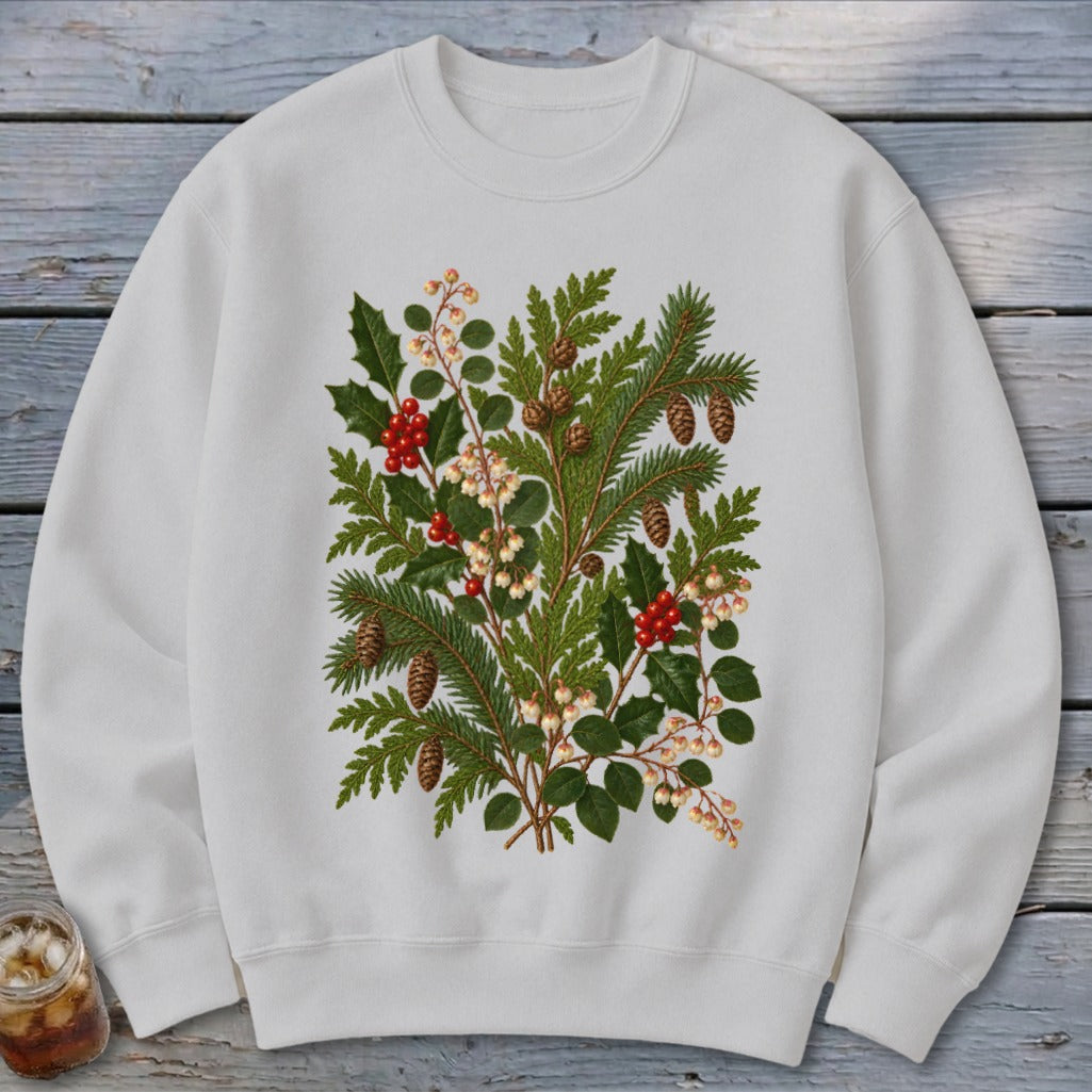 White sweatshirt with a detailed botanical illustration of pine branches, holly, and berries.