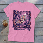 Pink t-shirt with a ghost in a forest and text: The Haints Ain't Left.