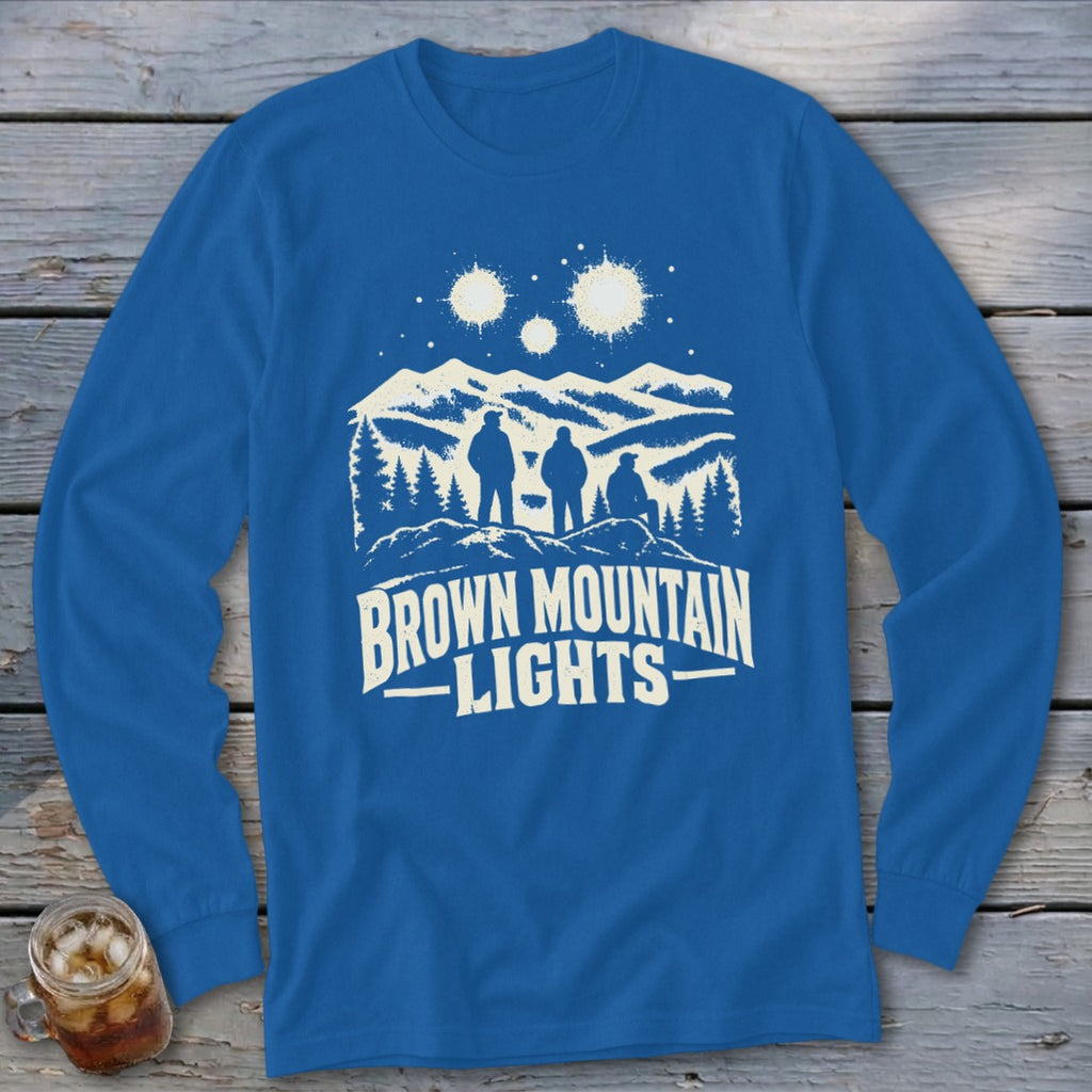 Royal blue long-sleeve t-shirt with a white graphic depicting mountains, trees, figures, and glowing lights above.