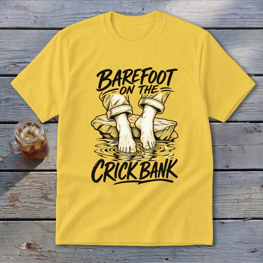 Yellow t-shirt with "Barefoot on the Crick Bank" graphic of feet in water.