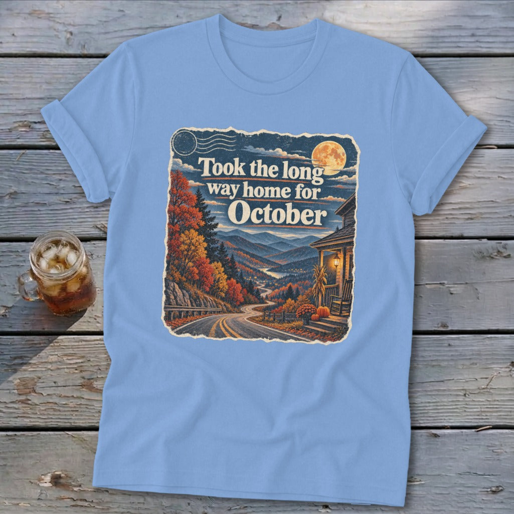 Blue t-shirt with autumn landscape graphic and text "Took the long way home for October".