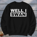 A black crewneck sweatshirt features bold white text that reads WELL I SWAN on the chest.