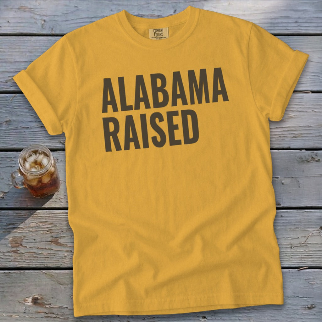 Yellow t-shirt with "ALABAMA RAISED" text, featuring a mug of iced tea.