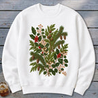 White crewneck sweatshirt with a vintage-style botanical print of pine, holly, and berries.