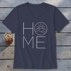 A dark blue V-neck t-shirt with a white graphic spelling "HOME," featuring a mountain and sun design inside the letter O.