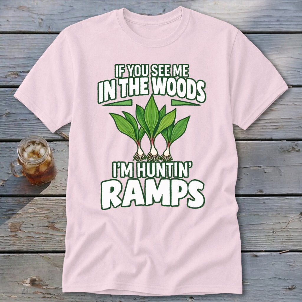 A light pink t-shirt with green text reading IF YOU SEE ME IN THE WOODS I'M HUNTIN RAMPS and an illustration of ramps.