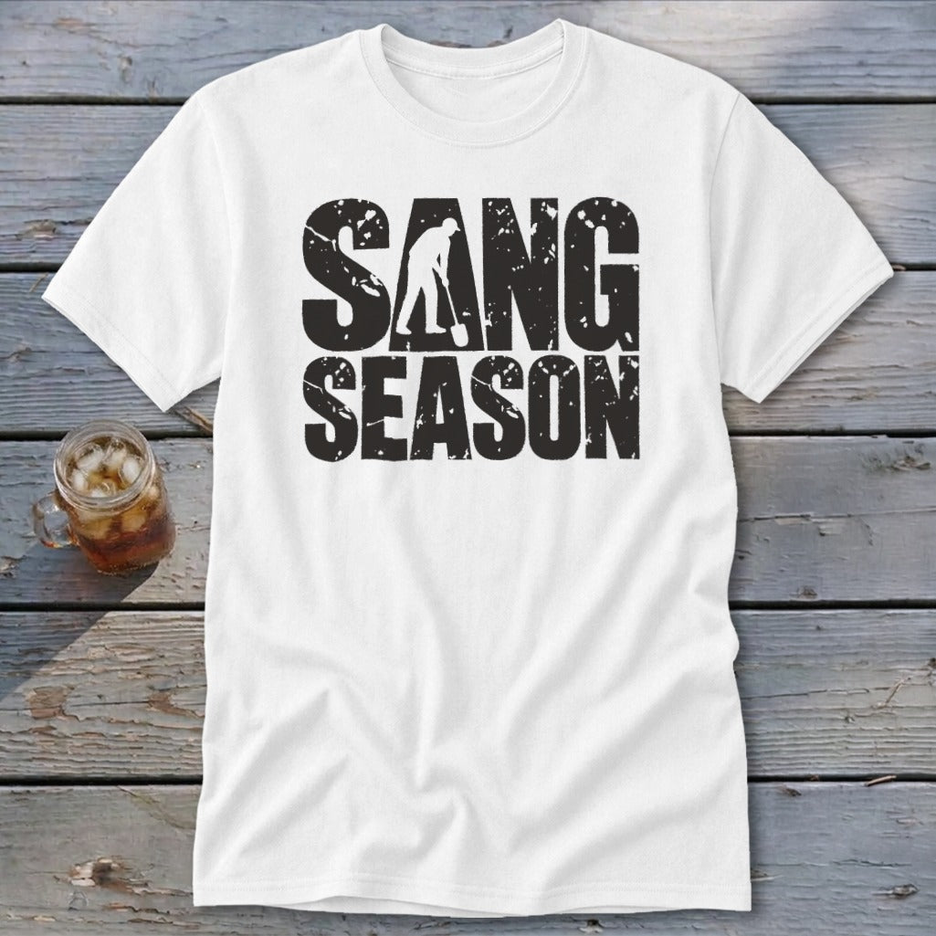 A white t-shirt featuring the distressed black text SANG SEASON with a silhouette of a person digging.