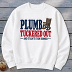 White sweatshirt with "PLUMB TUCKERED OUT" and rocking chair graphic.