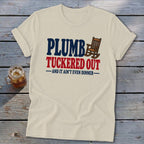Cream t-shirt with "PLUMB TUCKERED OUT AND IT AIN'T EVEN DINNER" text and rocking chair.
