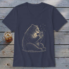 Bear holding a jar of fireflies with stars around it on a navy shirt.