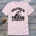 Light pink t-shirt with black text and oil pump graphic: "OILFIELD TRASH AND PROUD OF IT".