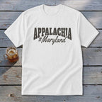 White t-shirt with "APPALACHIA #Maryland" graphic, next to a glass of iced drink.