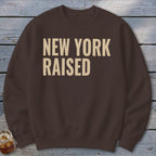 Brown sweatshirt with "NEW YORK RAISED" printed in beige text.