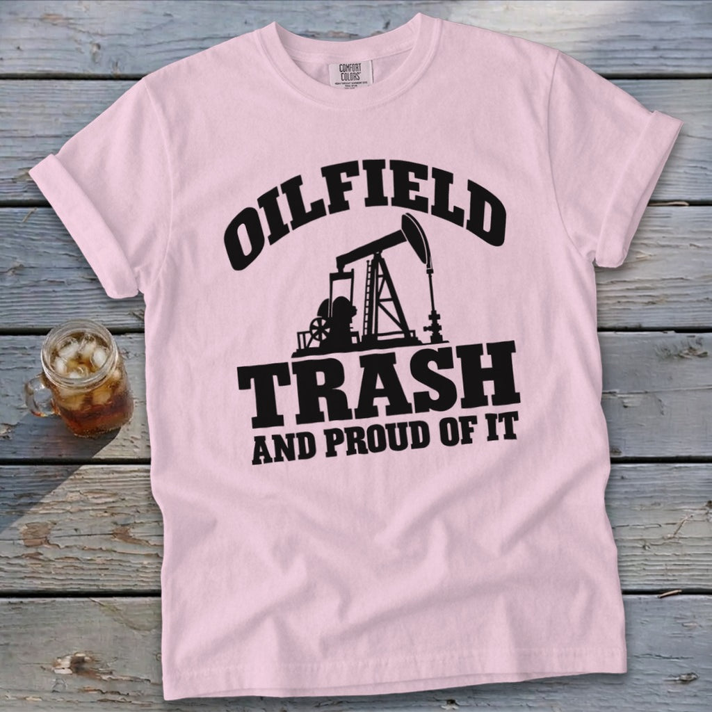 Pink t-shirt with black text "OILFIELD TRASH AND PROUD OF IT" and oil rig graphic.