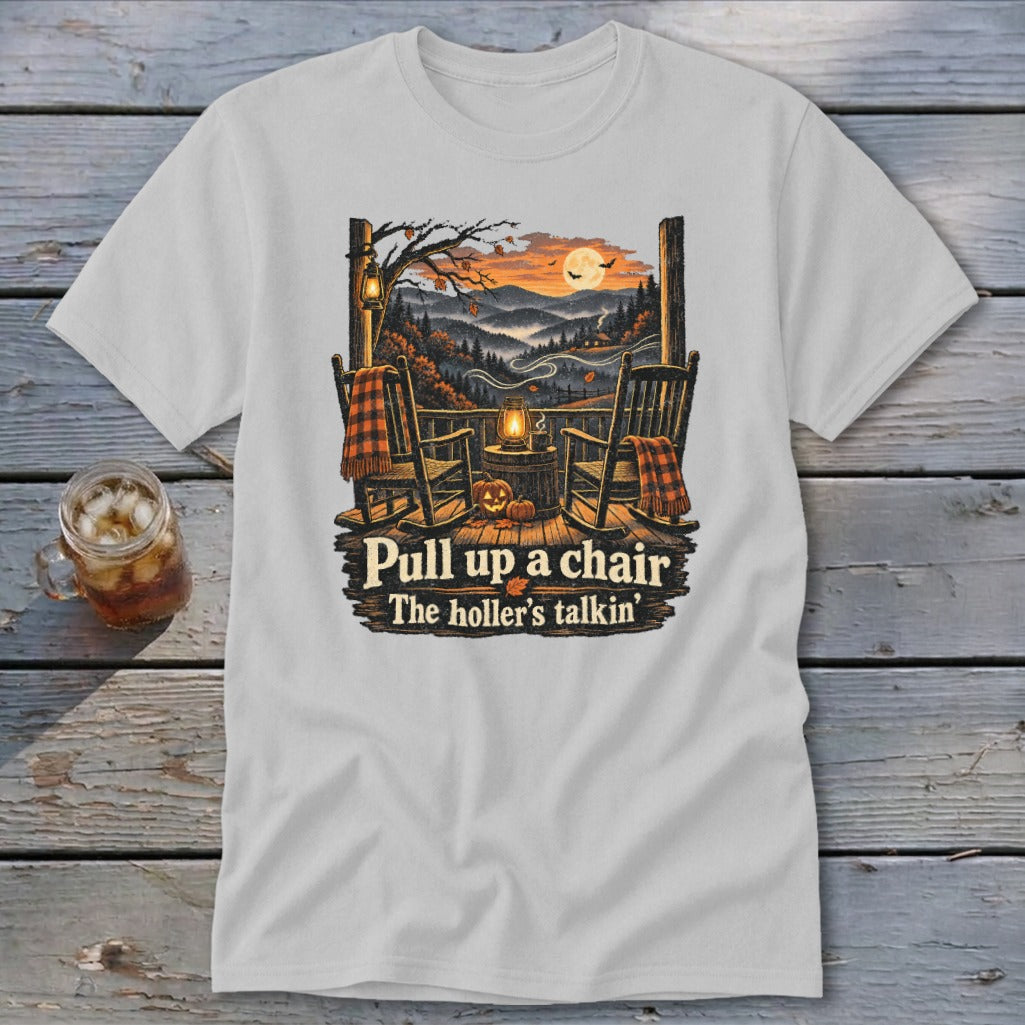 T-shirt graphic of porch with rocking chairs, autumn landscape, and text "Pull up a chair, The holler's talkin'".