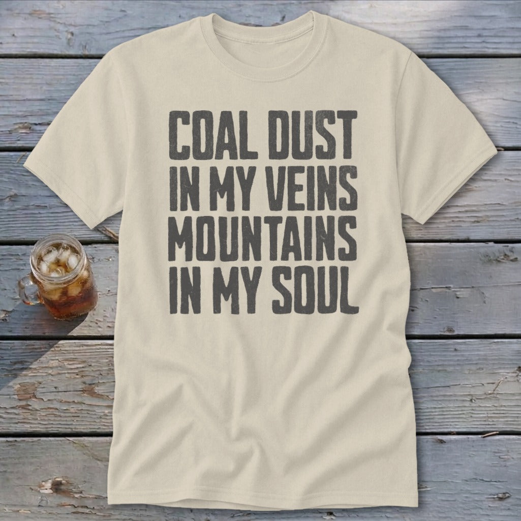 Cream-colored crewneck t-shirt with charcoal text reading "COAL DUST IN MY VEINS MOUNTAINS IN MY SOUL".