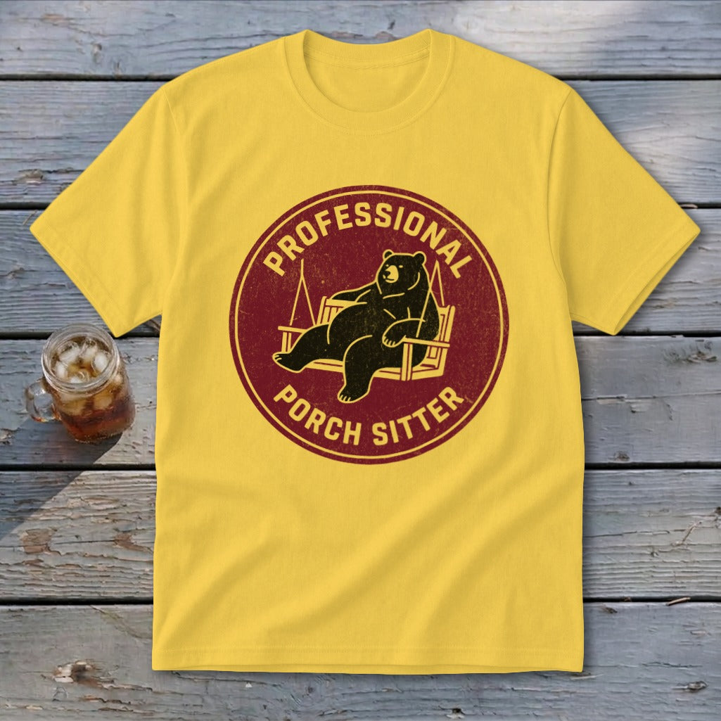 Yellow crewneck t-shirt featuring a circular graphic of a bear relaxing in a porch swing with text.
