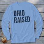 Light blue long sleeve shirt with "OHIO RAISED" printed in dark blue.