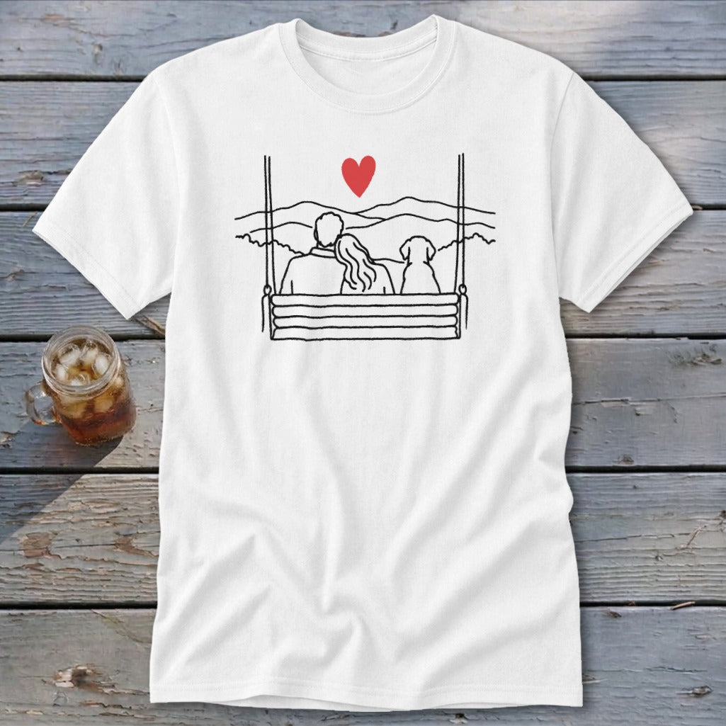 Couple and dog on a swing with a heart above and mountain landscape.