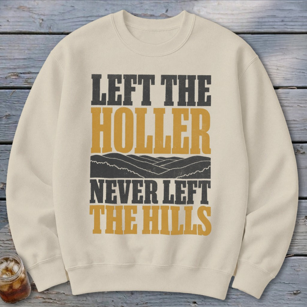 Cream sweatshirt with text "LEFT THE HOLLER NEVER LEFT THE HILLS" and mountain graphic.