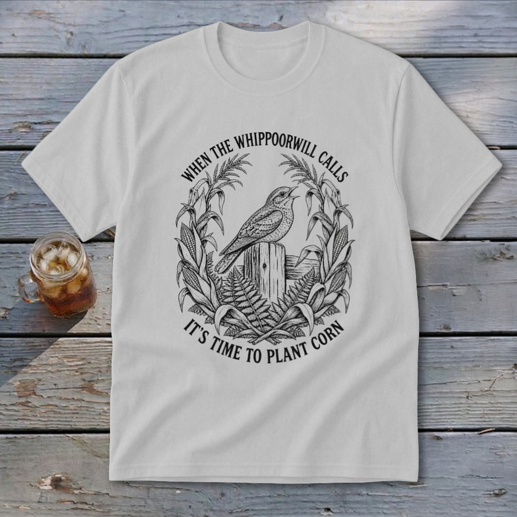 Light gray t-shirt featuring a black circular graphic of a bird, cornstalks, and text.