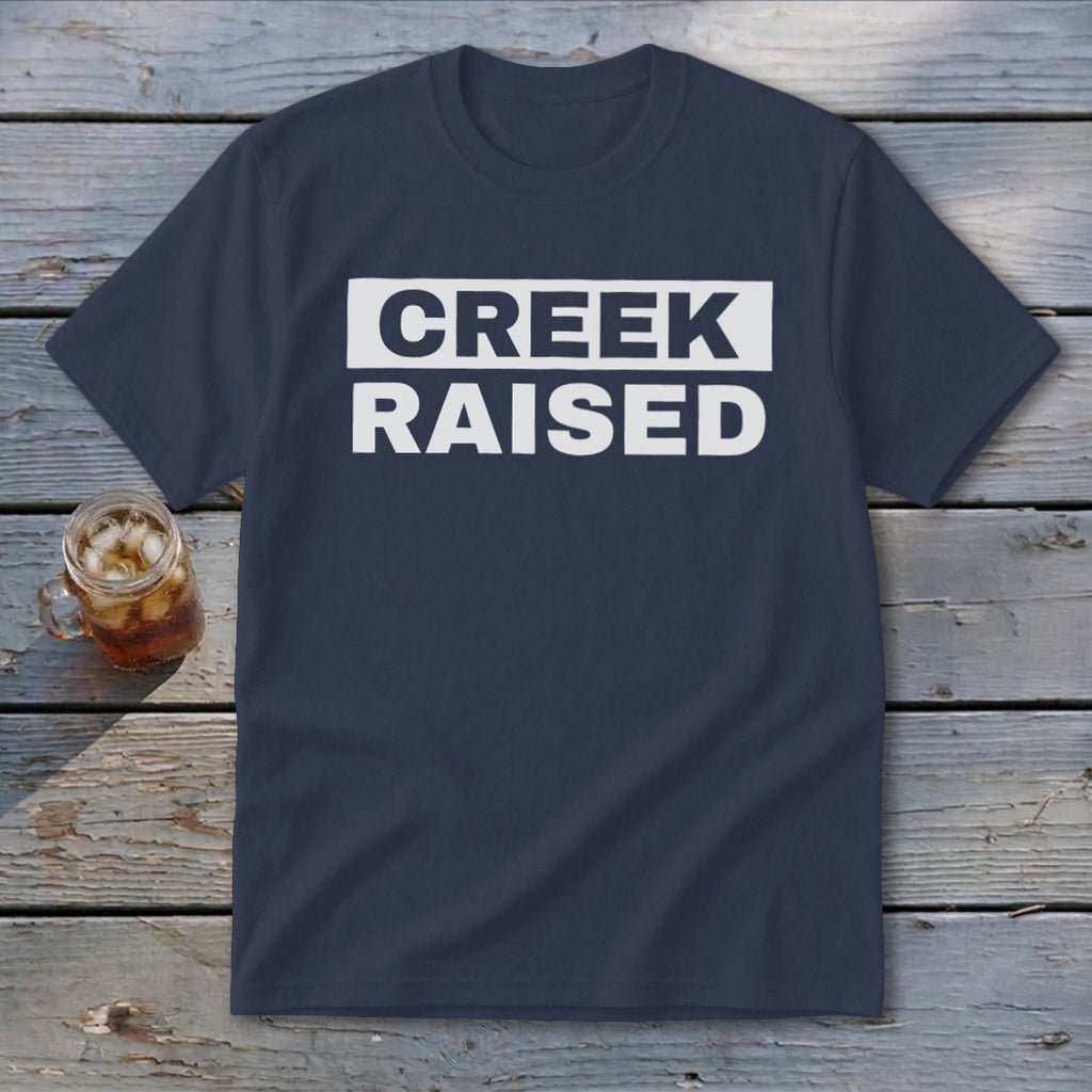 Navy t-shirt with white text reading "CREEK RAISED"