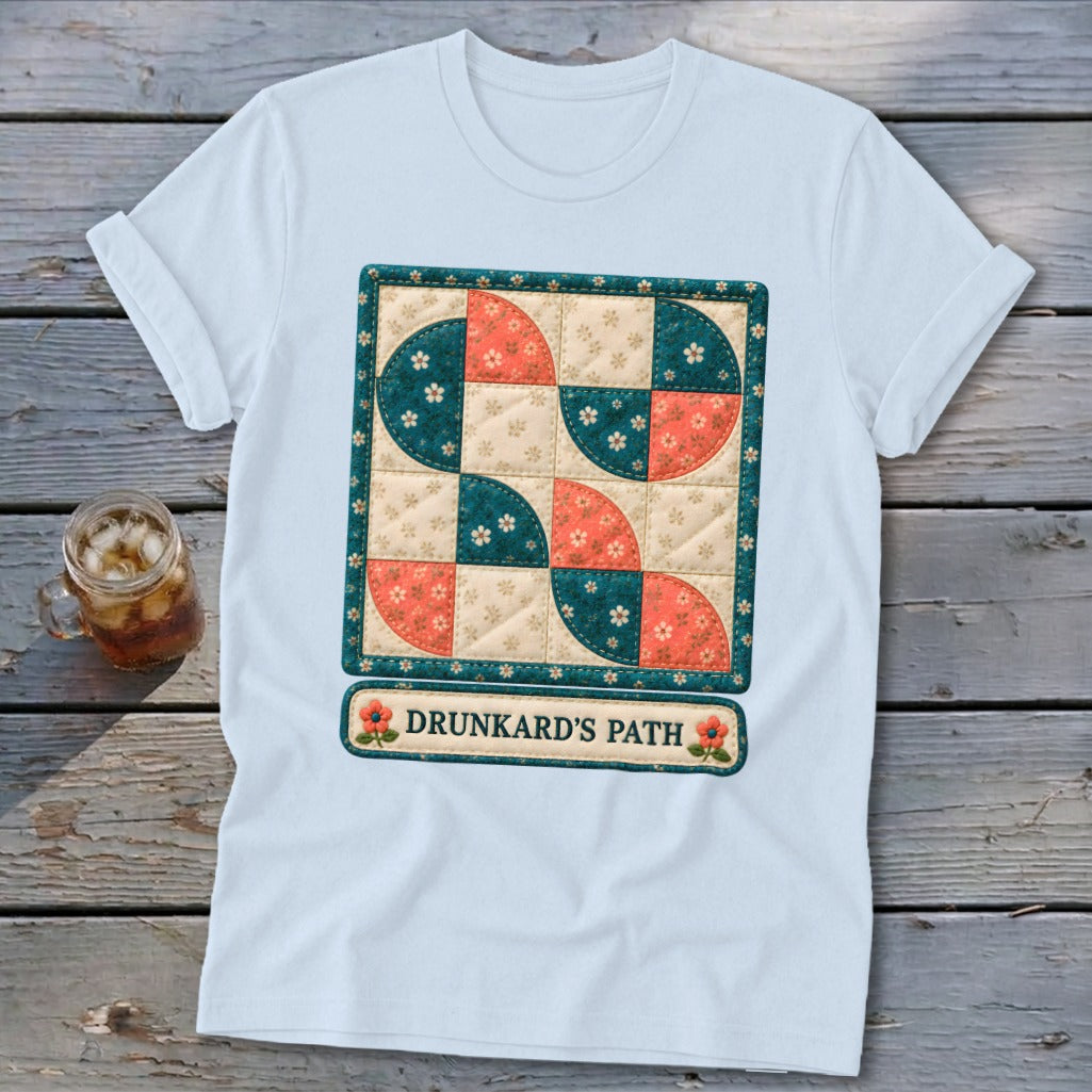 White t-shirt with a quilt block design labeled "Drunkard's Path".