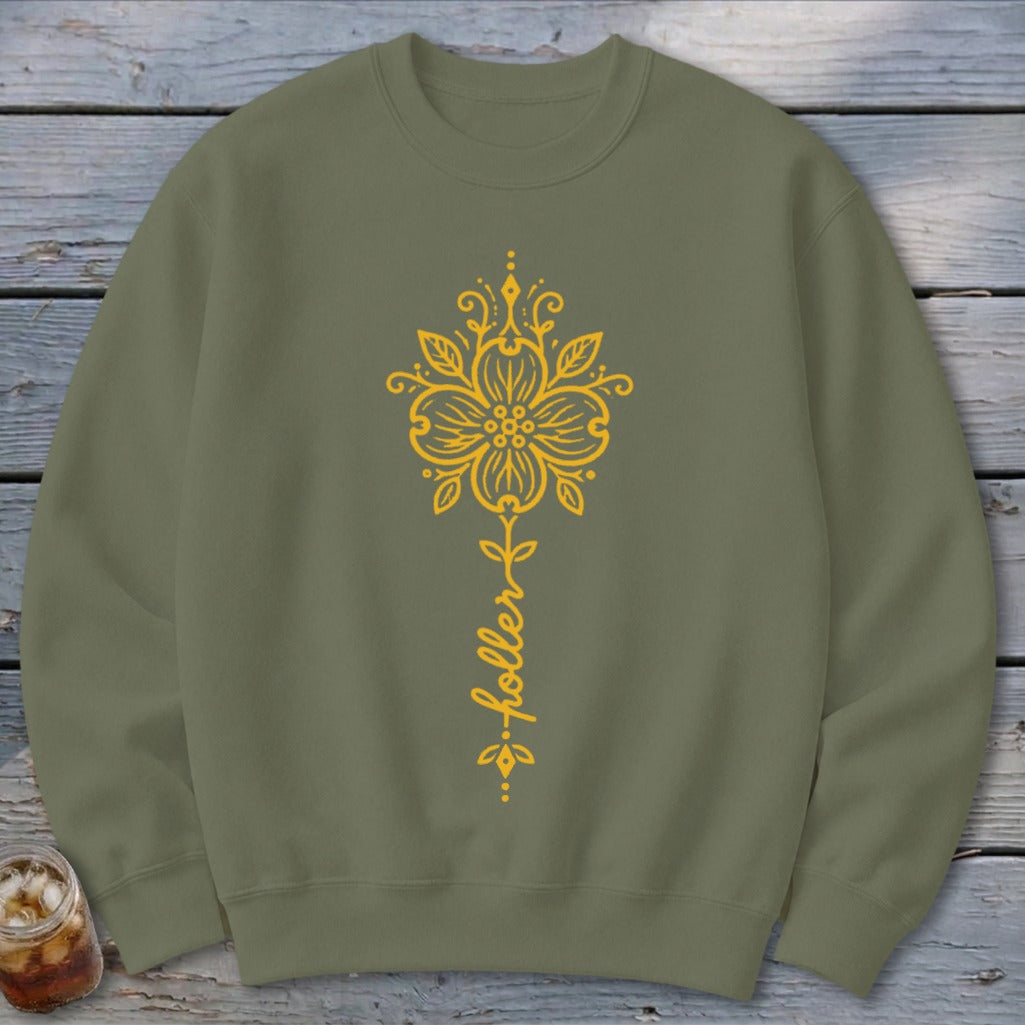 Olive green sweatshirt with yellow floral design and the word "holler".