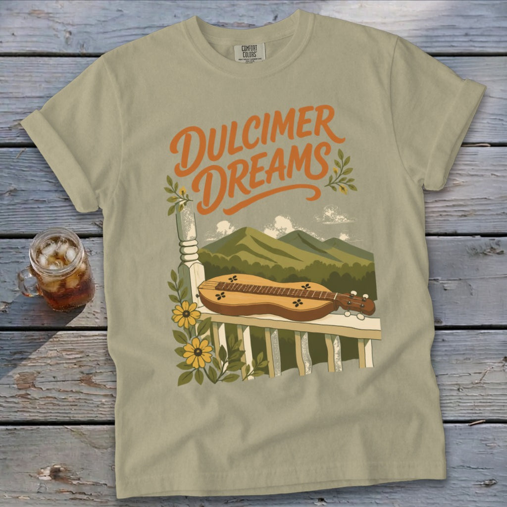 Light tan t-shirt with "Dulcimer Dreams" text and a dulcimer on a railing.
