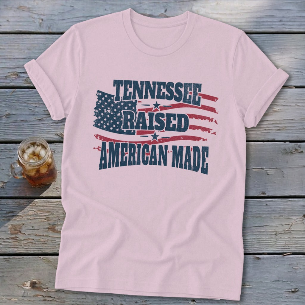 Pink t-shirt with "Tennessee Raised American Made" text and American flag graphic.