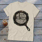 Cream t-shirt with "NO SUGAR IN THE CORNBREAD" text inside a cast iron skillet graphic.